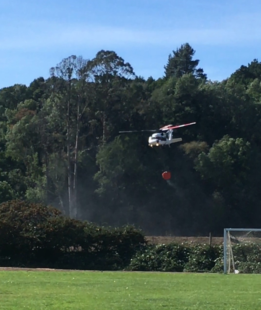 Helecopter filling water bucket